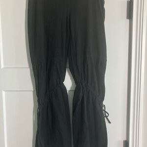 Neon Buddha cotton black pant with ties on both knees and flaring at the bottom